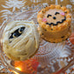jack-o-lantern and mummy decorated mini cakes