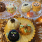 white pumpkin, orange pumpkin, black cat, jack-o-lantern and mummy, ghost and werewolf mini cakes