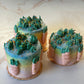 Pair of carrots and grass with pink, yellow and blue ombre design on a marble surface